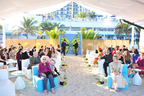Beach wedding ceremony tent butterfly gate turquoise and white couches